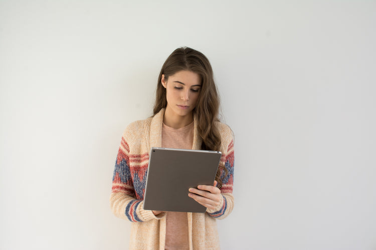 Woman writing on ipad with tinymoose stylus pen 